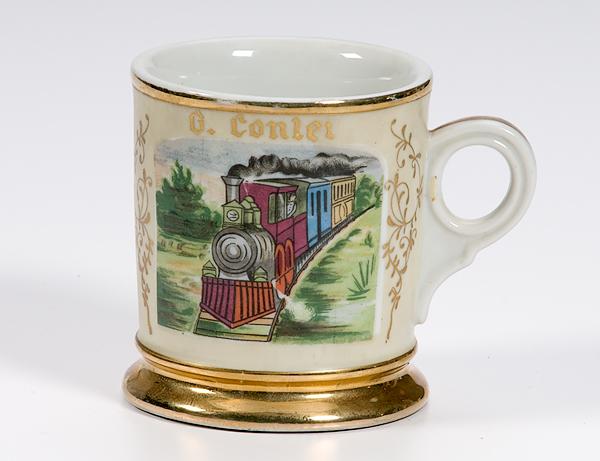 Appraisal: TRAIN SHAVING MUG Porcelain mug with gilding with painting of