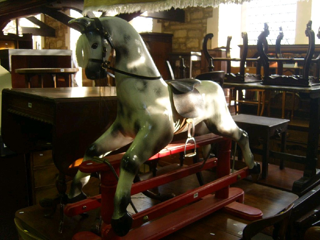 Appraisal: A modern dapple grey rocking horse on red painted base