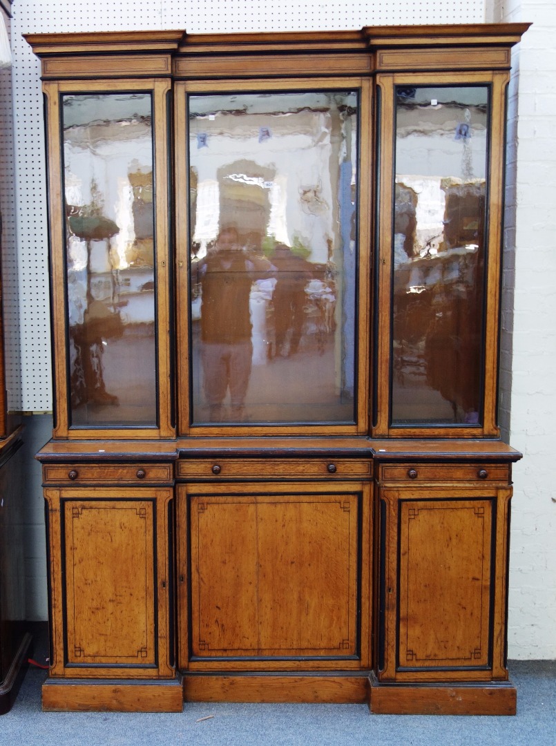 Appraisal: A th century oak and ebonised inverted breakfront bookcase cupboard