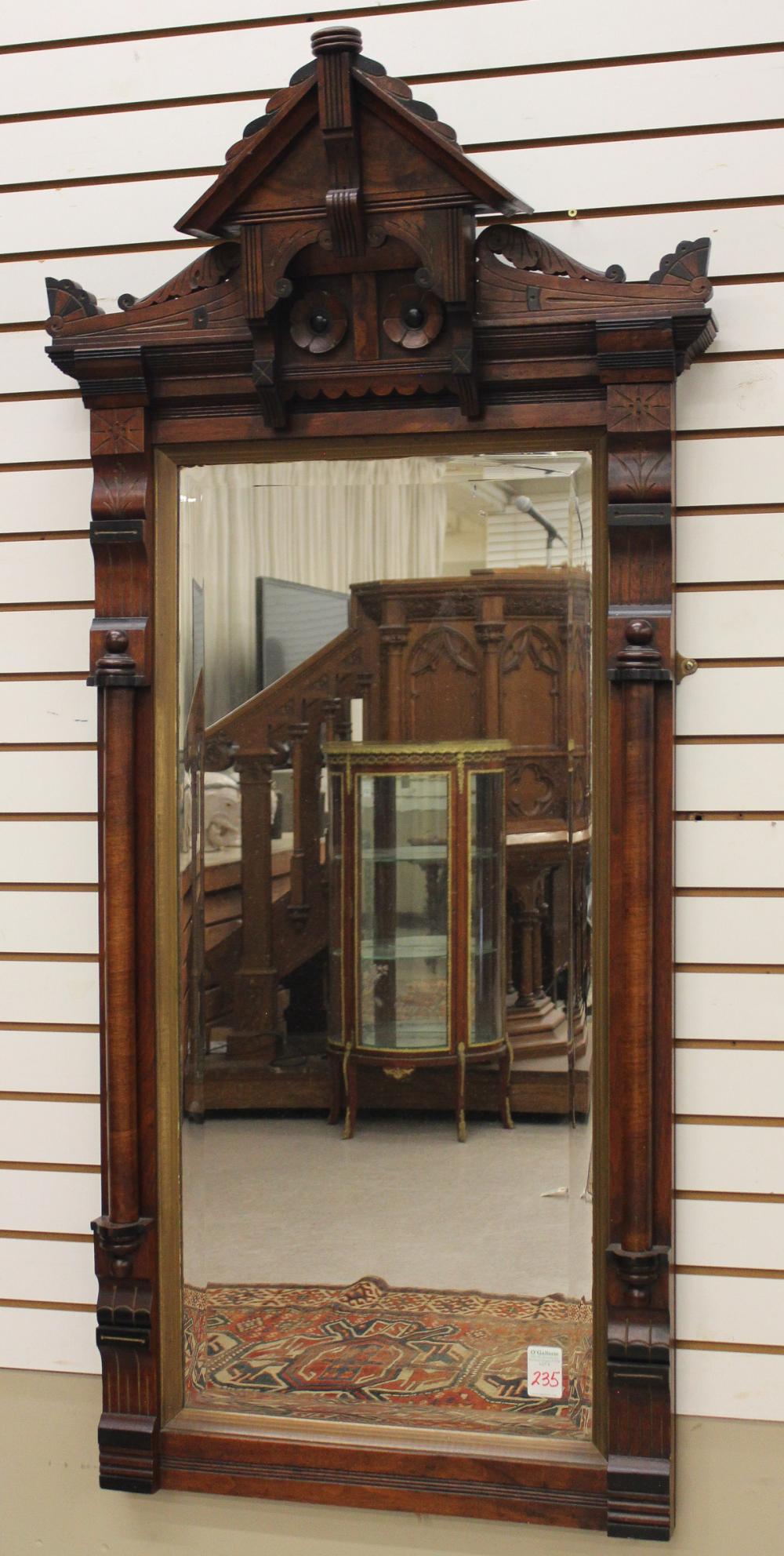 Appraisal: VICTORIAN WALNUT-FRAMED WALL MIRROR Charles Eastlake design American last quarter