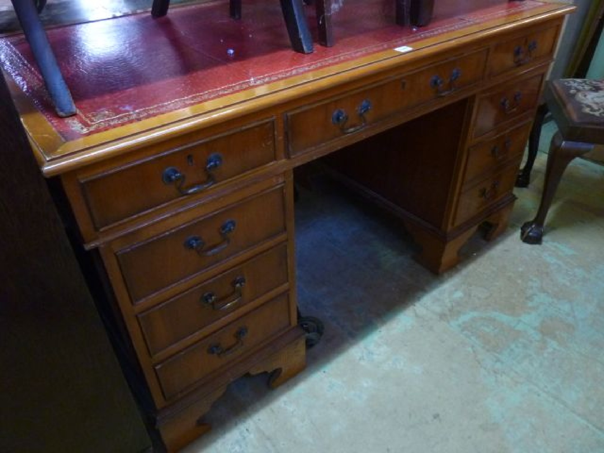 Appraisal: A Georgian style pedestal desk fitted with nine drawers with