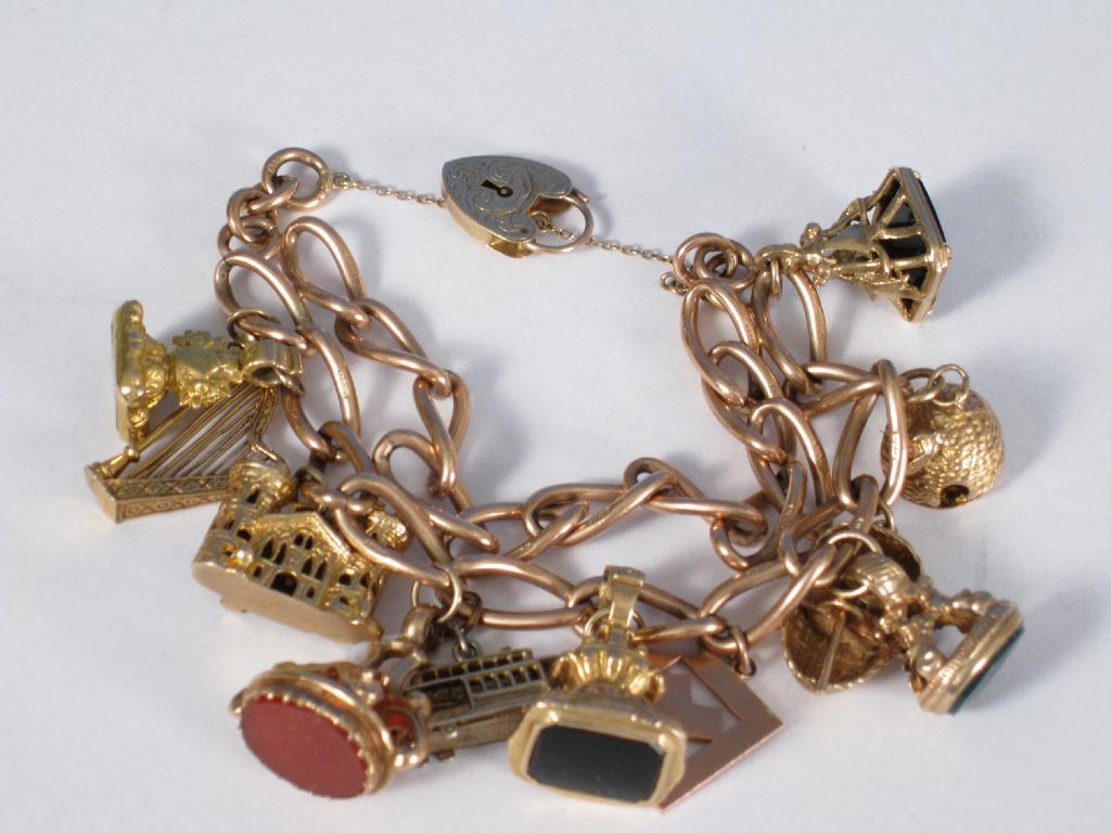 Appraisal: A ct gold Bracelet with numerous charms including harp seal