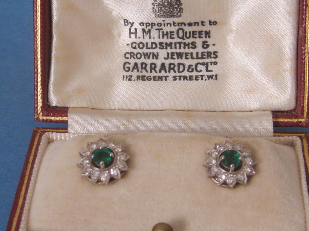 Appraisal: Pair of Earrings set central emerald surrounded by twelve diamonds