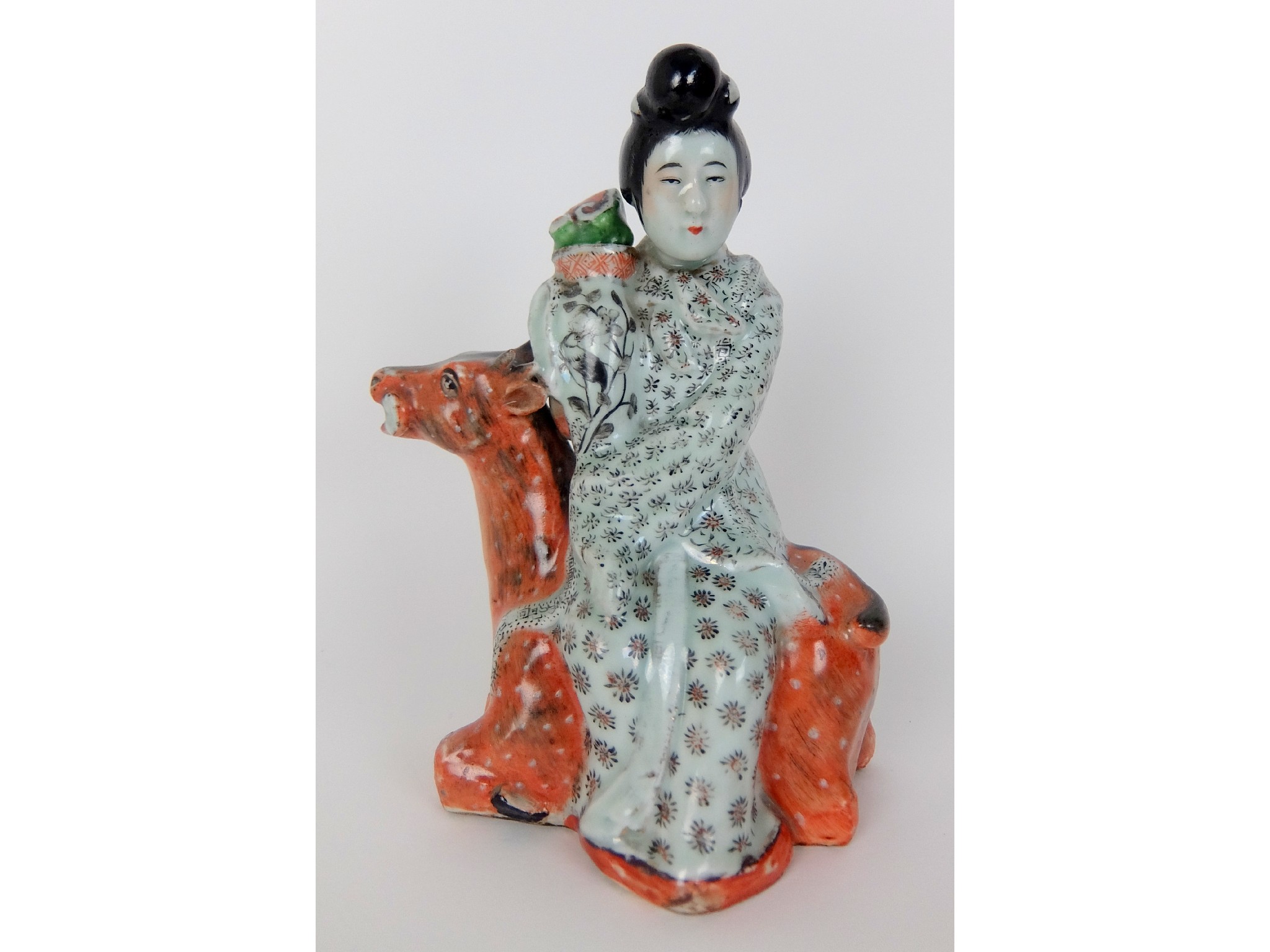 Appraisal: A Chinese teapotmodelled as a woman holding a vase seated