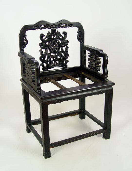 Appraisal: CARVED CHINESE ARM CHAIR Pierce carved panels to back and