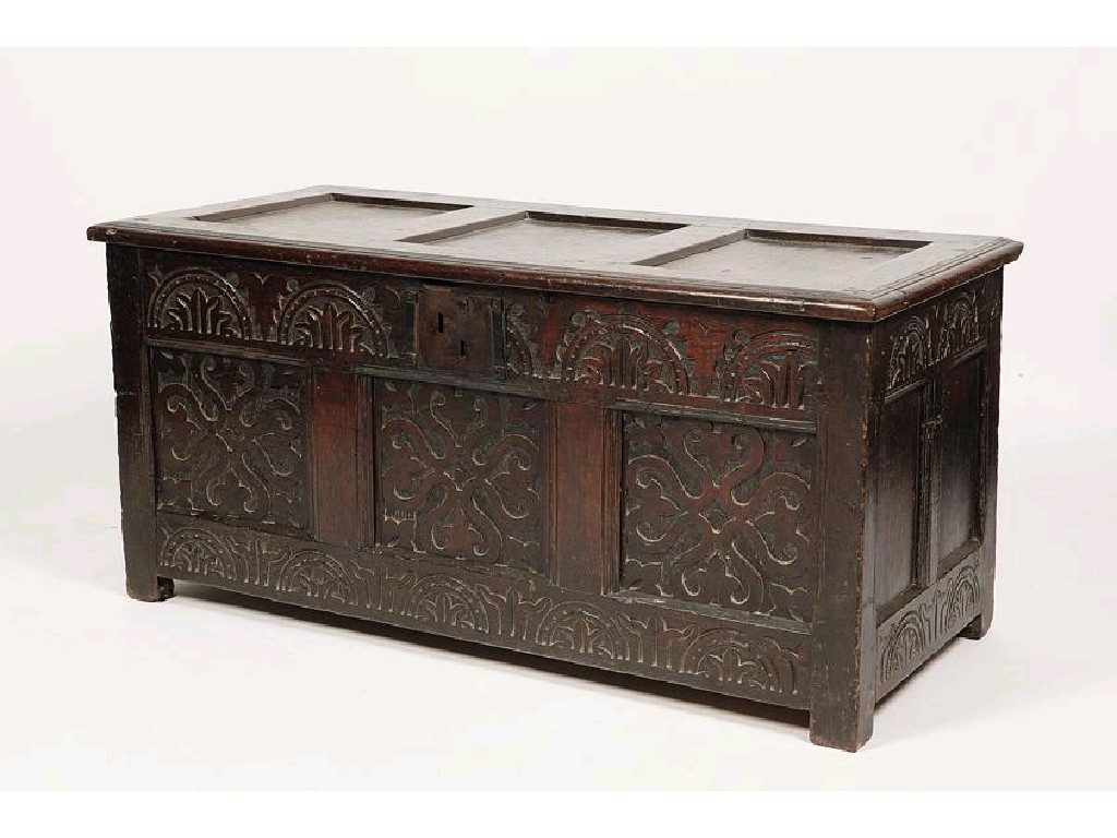 Appraisal: A CHARLES II OAK COFFER the rising three panel lid