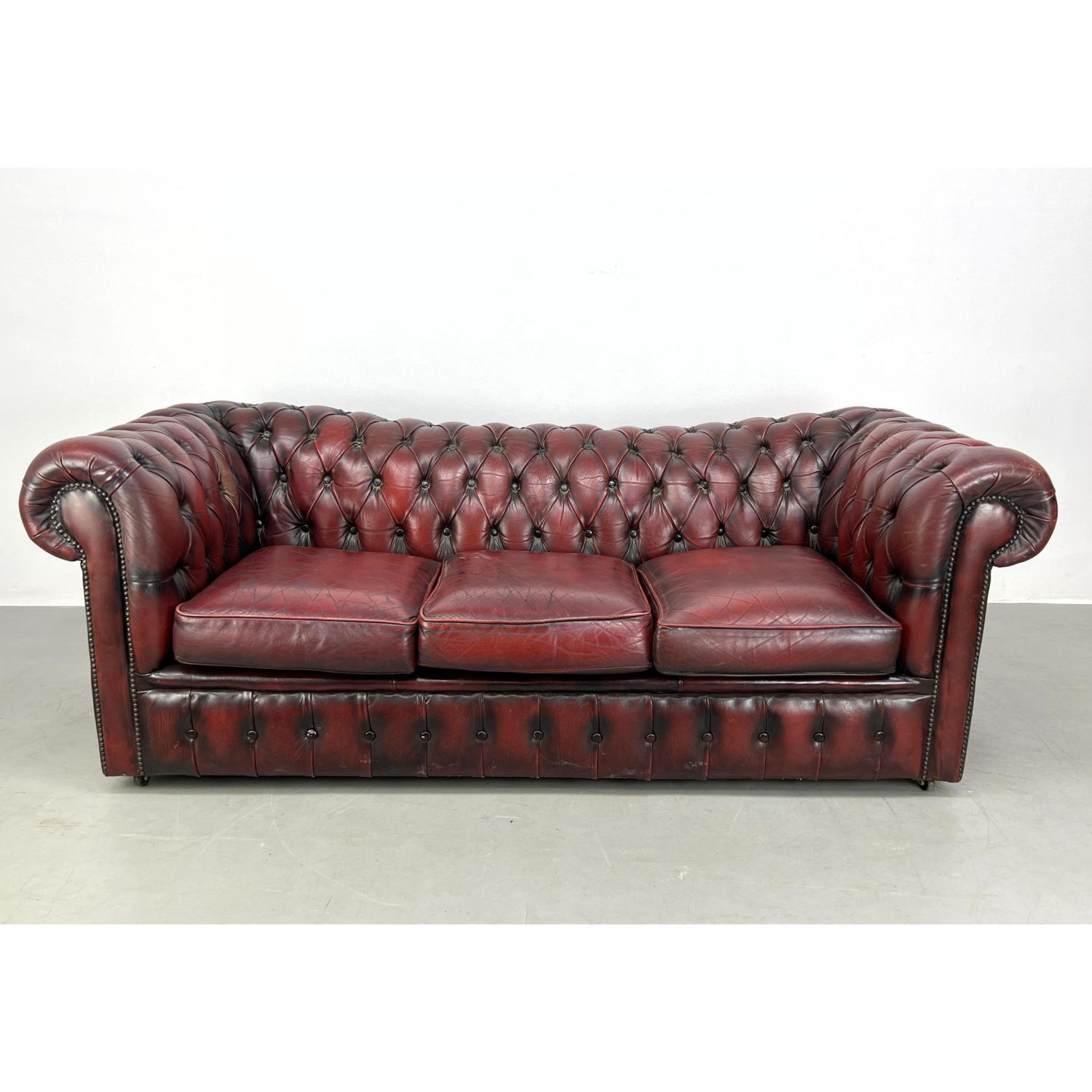 Appraisal: Burgundy Tufted Leather Chesterfield Sofa Couch Rolled Ams Metal stud