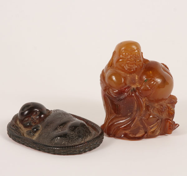 Appraisal: Cherry amber oriental figures carved swaddled sleeping infant and bulbous