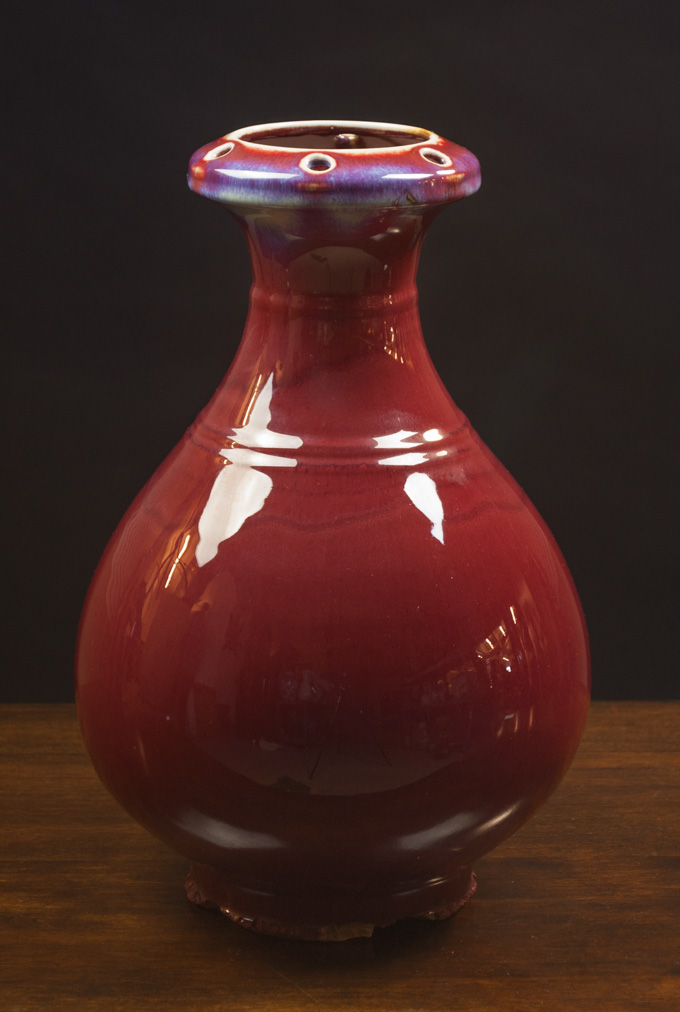 Appraisal: CHINESE FLAMBE YUHUCHUN VASE the lip rim pierced with six