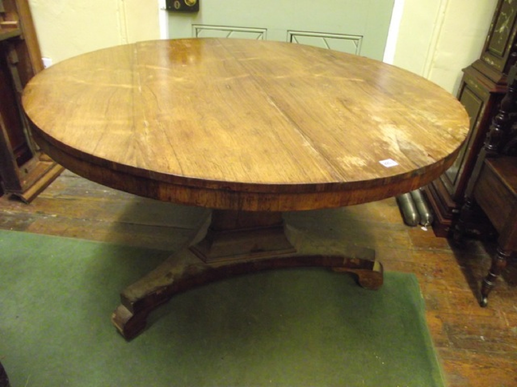 Appraisal: A Regency rosewood tea table the circular top raised on