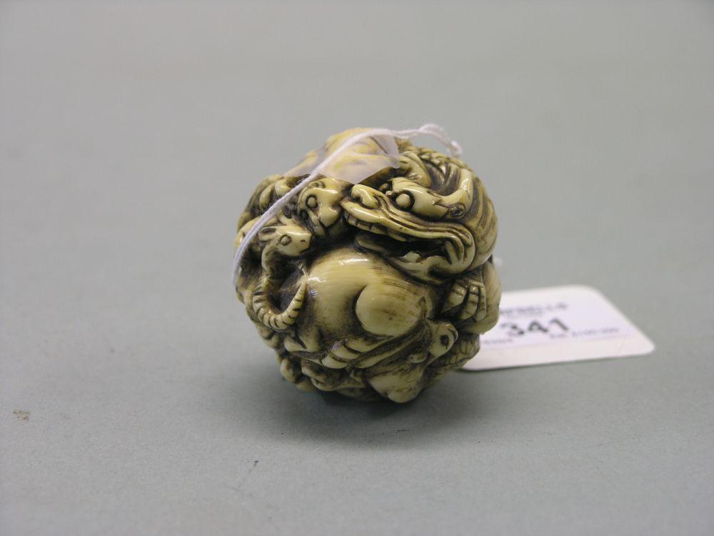 Appraisal: A Japanese ivory okimono Meiji period globular shape carved with