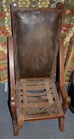 Appraisal: A LATE VICTORIAN OAK ARMCHAIR with angular supports and adjustable