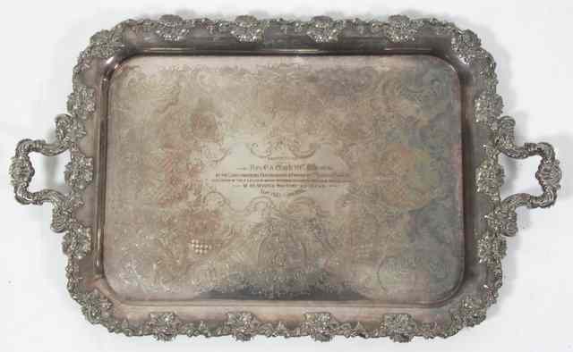 Appraisal: A silver plated presentation tray with scroll handles and border