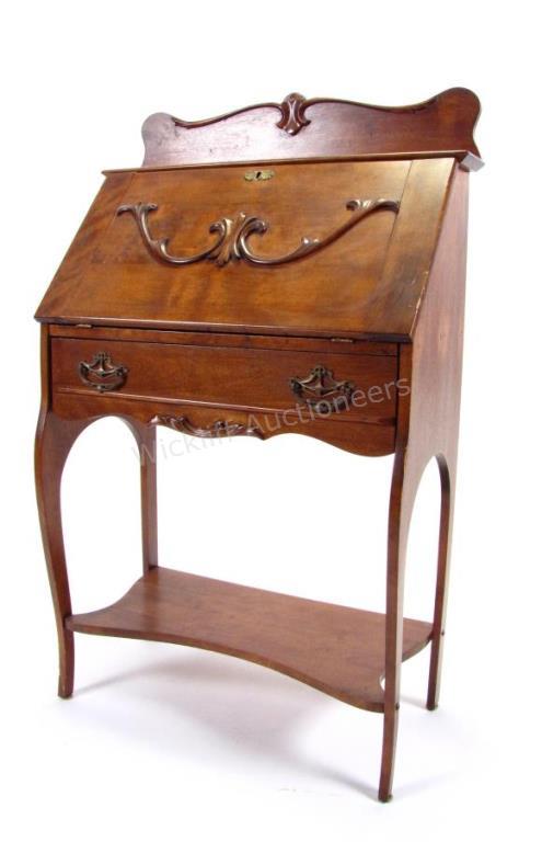 Appraisal: An antique slant front desk-secretary removable fitted interior applied carvings