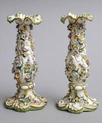 Appraisal: PAIR OF PORCELAIN FLORAL ENCRUSTED VASES Each slender baluster bowl