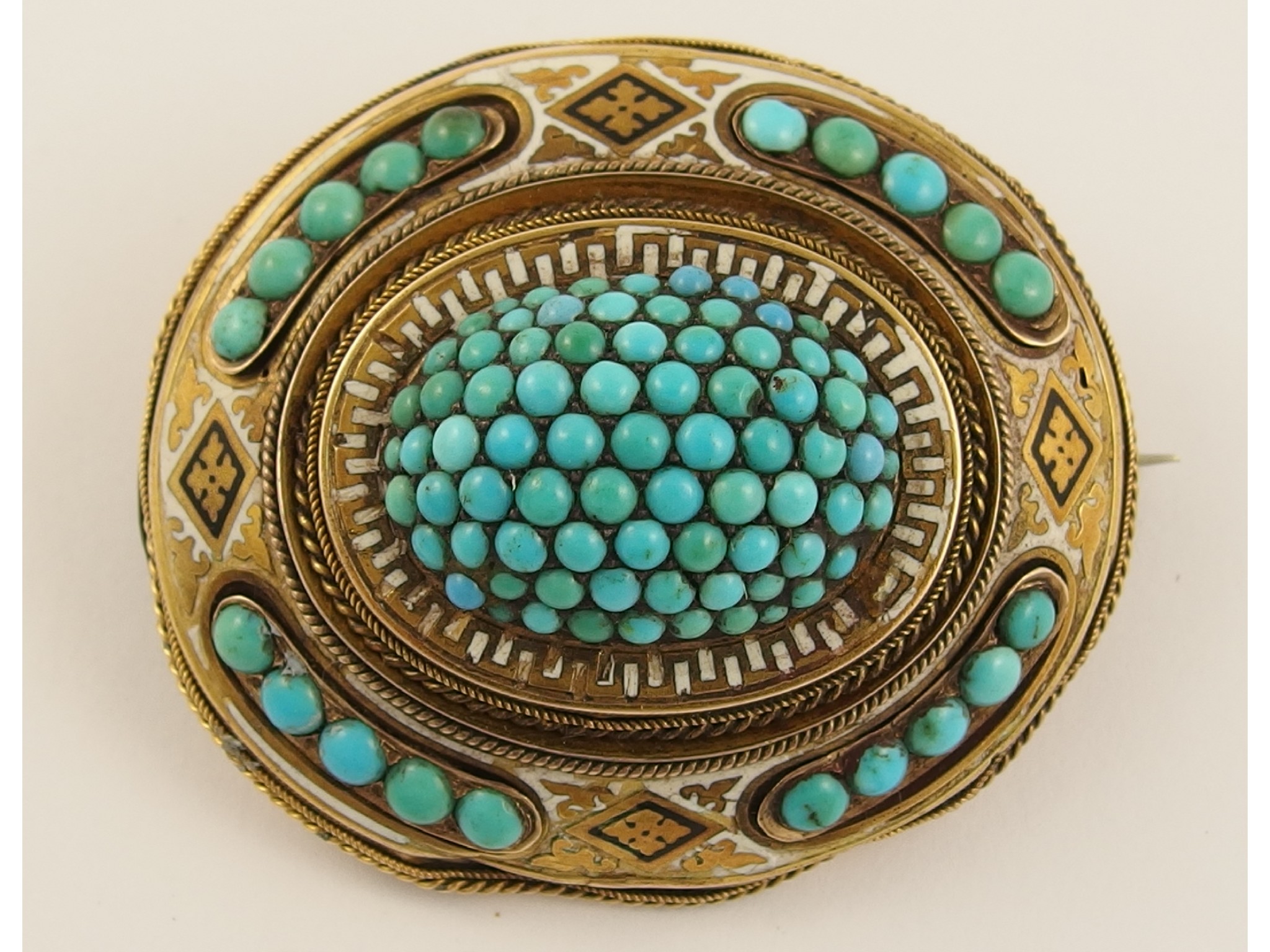 Appraisal: A Victorian enamel and turquoise set broochenamelled in black and