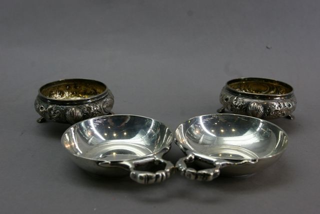 Appraisal: A pair of Victorian silver footed salts with repousse floral