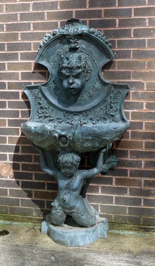 Appraisal: A grey patinated metal water spout the satyr mask upon