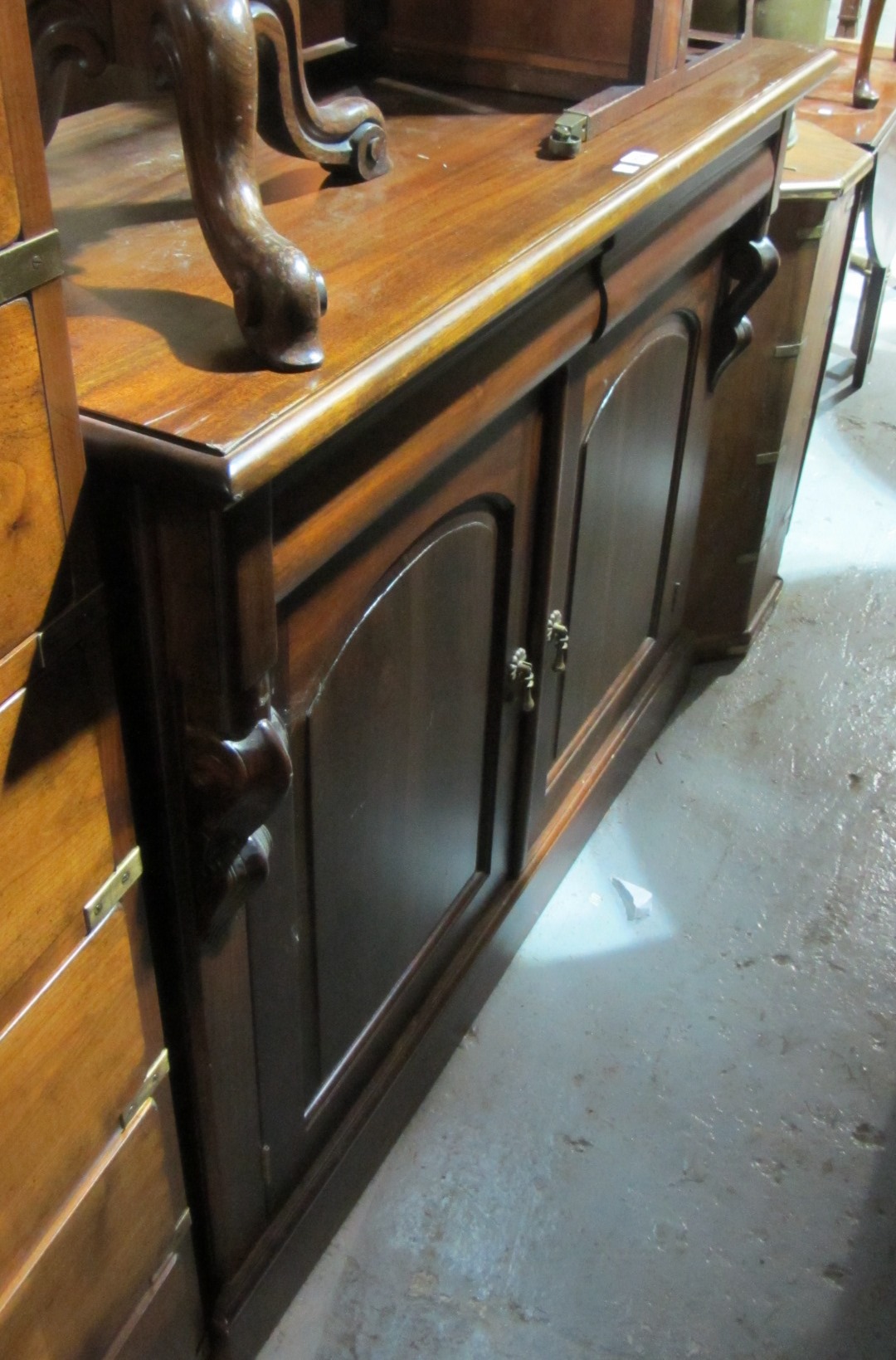 Appraisal: A th century mahogany bookcase cupboard with two flush fitted