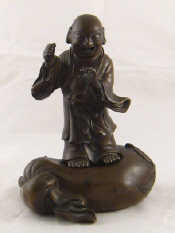 Appraisal: A Chinese bronze of a laughing figure standing on a