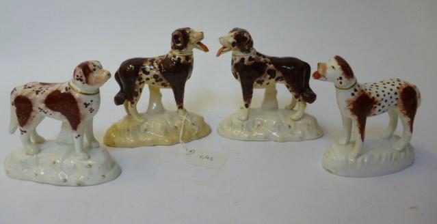 Appraisal: A PAIR OF STAFFORDSHIRE POTTERY DOGS th century standing with