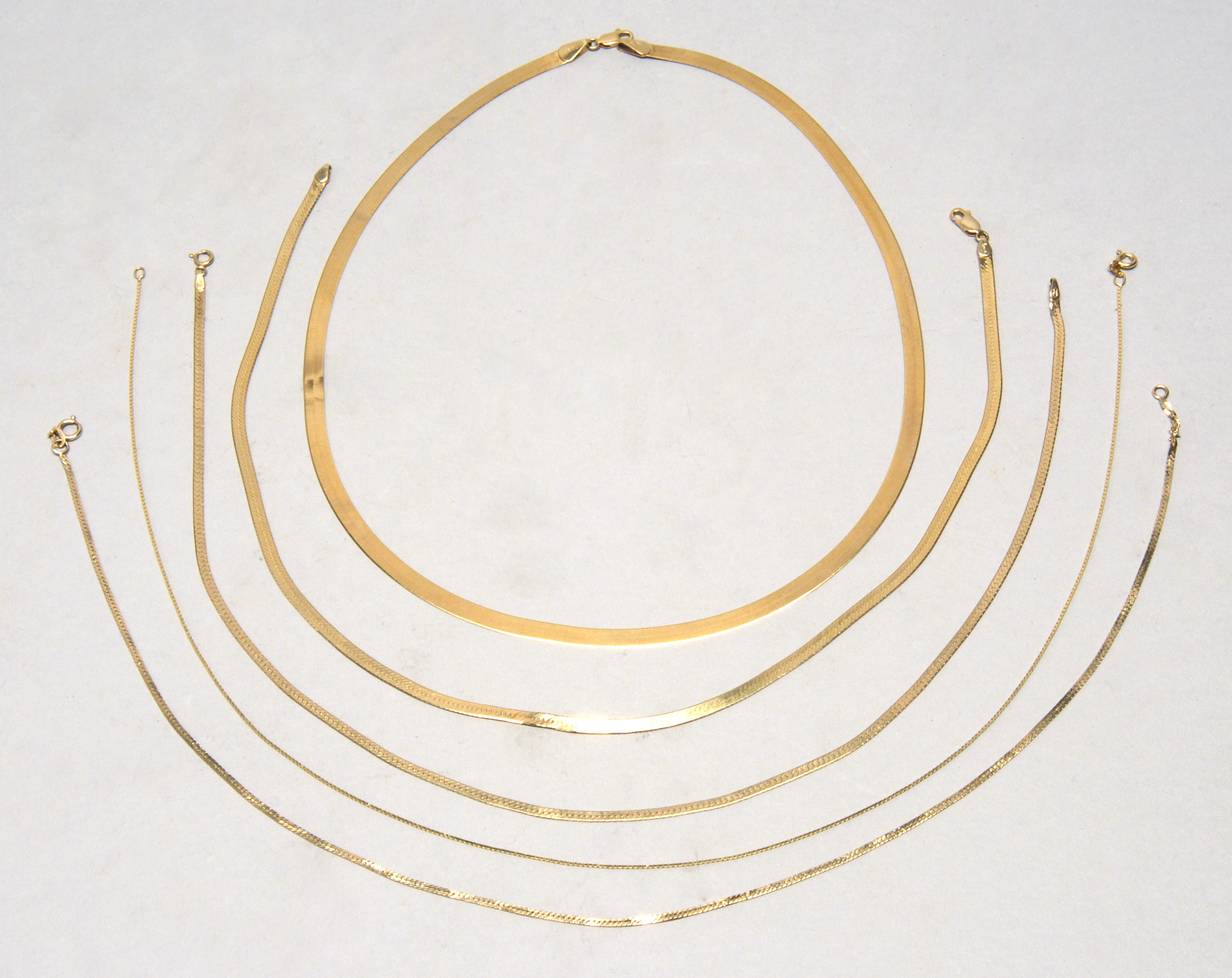 Appraisal: FIVE GOLD CHAIN NECKLACES Three kt gold herringbone chain necklaces