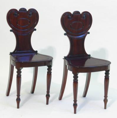 Appraisal: A PAIR OF MAHOGANY HALL CHAIRS the waisted back with