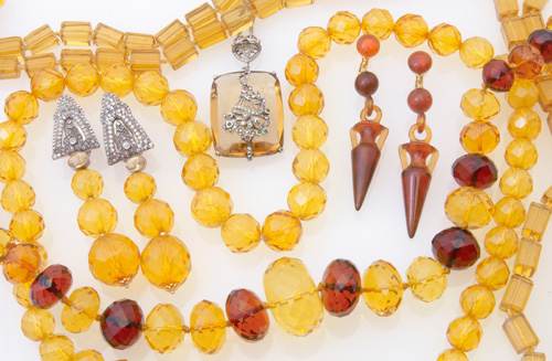 Appraisal: Nine Art Deco amber and amber glass jewelry pieces urn-shaped