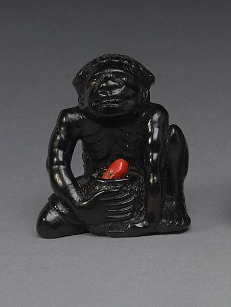 Appraisal: An ebony figural study with coral th Century Fashioned as