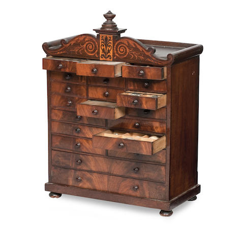 Appraisal: A late Regency Mahogany and inlaid specimen cabinet The scrolling