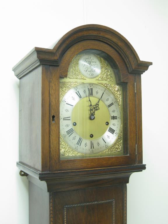 Appraisal: A Grandmother Clock with arched brass dial having silvered chapter