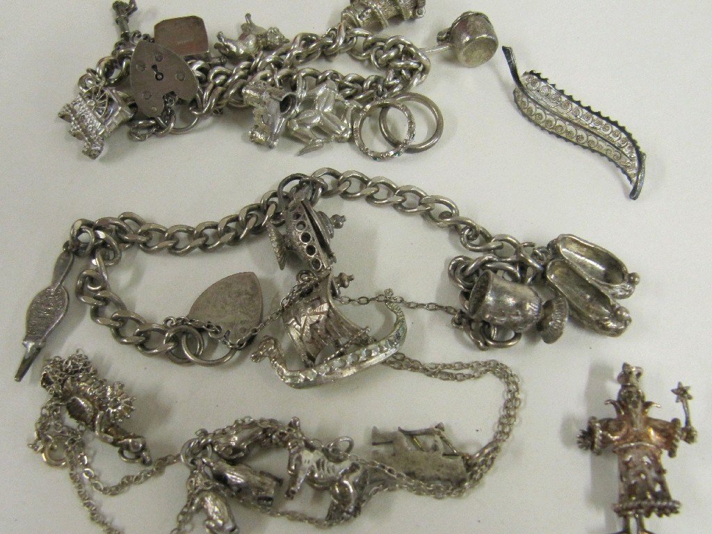 Appraisal: Lot comprising two silver charm bracelets and a leaf brooch