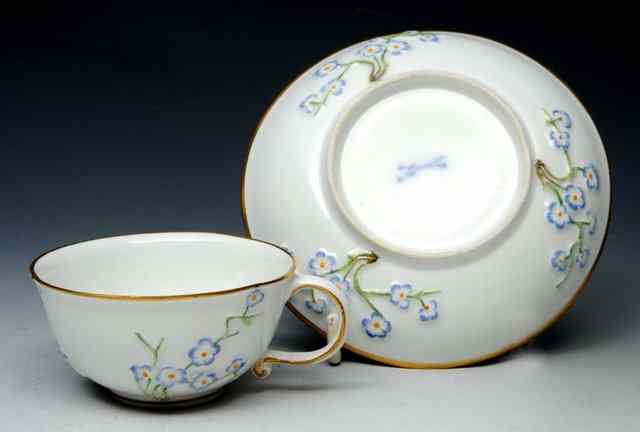 Appraisal: A MEISSEN TEACUP and saucer circa with 'hausmaler' decoration embossed