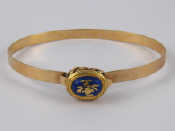 Appraisal: A yellow metal tests carat gold bangle with an enamelled