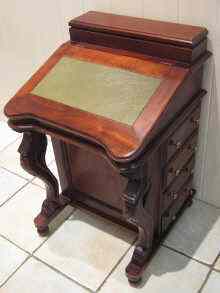 Appraisal: A reproduction mahogany Davenport desk with eight drawers and stationery