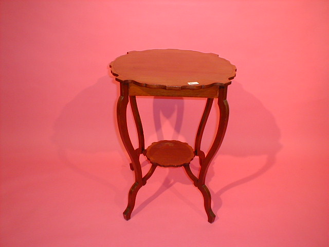 Appraisal: An Edwardian cross banded mahogany window table with shaped top