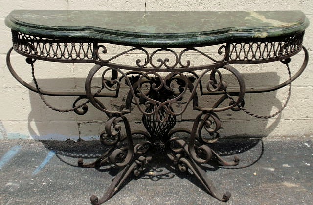 Appraisal: Wrought iron console table with an ornate base and green