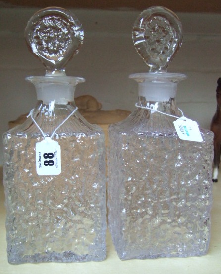 Appraisal: A matched pair of Whitefriars clear glass bark effect decanters