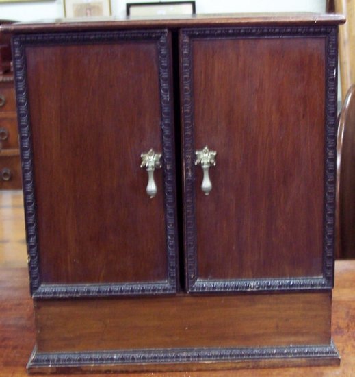 Appraisal: A stained beech cupboard fitted with two doors above a