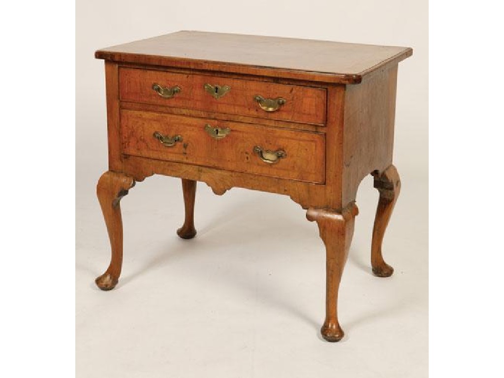 Appraisal: A GEORGE II WALNUT LOWBOY the rectangular crossbanded top with