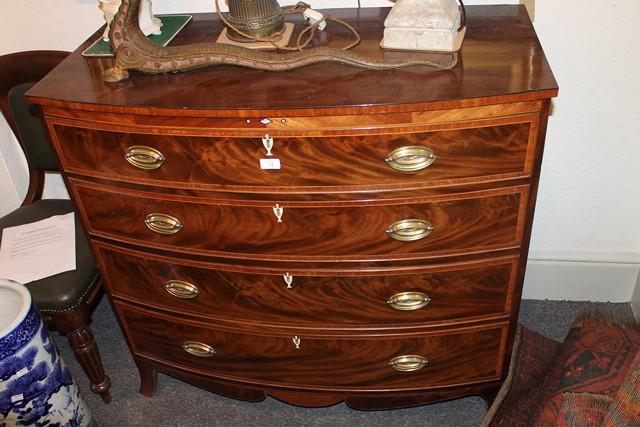 Appraisal: A GEORGIAN MAHOGANY BOW FRONT CHEST of four long graduated