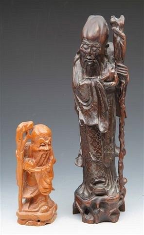 Appraisal: A CHINESE ROOTWOOD CARVING of a robed wise man with