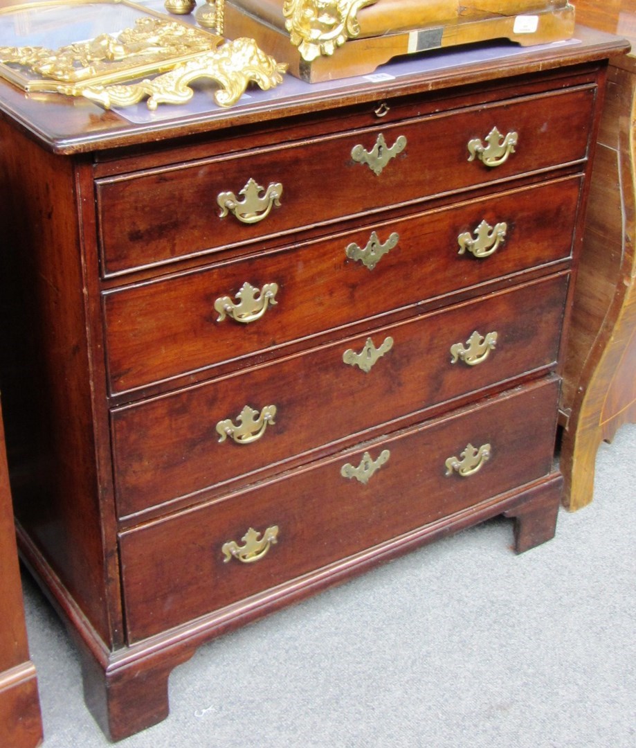 Appraisal: A George III mahogany chest the brushing slide over four