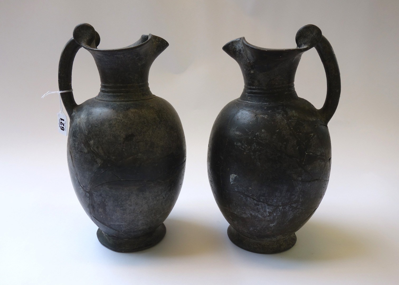 Appraisal: A pair of Etruscan Buchero jugs of reeded plain form