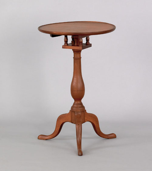 Appraisal: Pennsylvania walnut candlestand ca the dish top above a birdcage