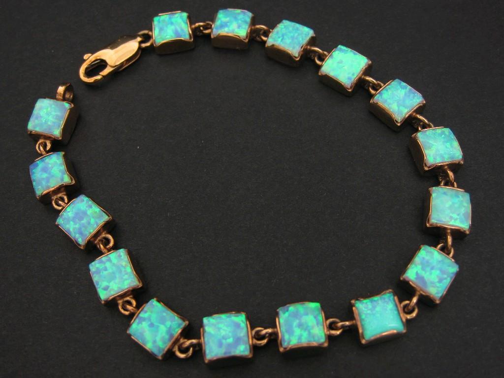 Appraisal: An Opal Line Bracelet collet-set sixteen square cabochons in gold