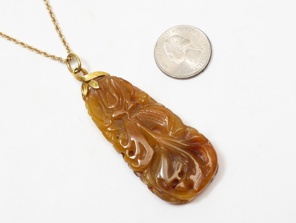 Appraisal: CARVED JADE PENDANT AND K GOLD CHAIN Carved brown jade