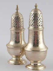 Appraisal: A matched pair of Georgian silver peppers each engraved with