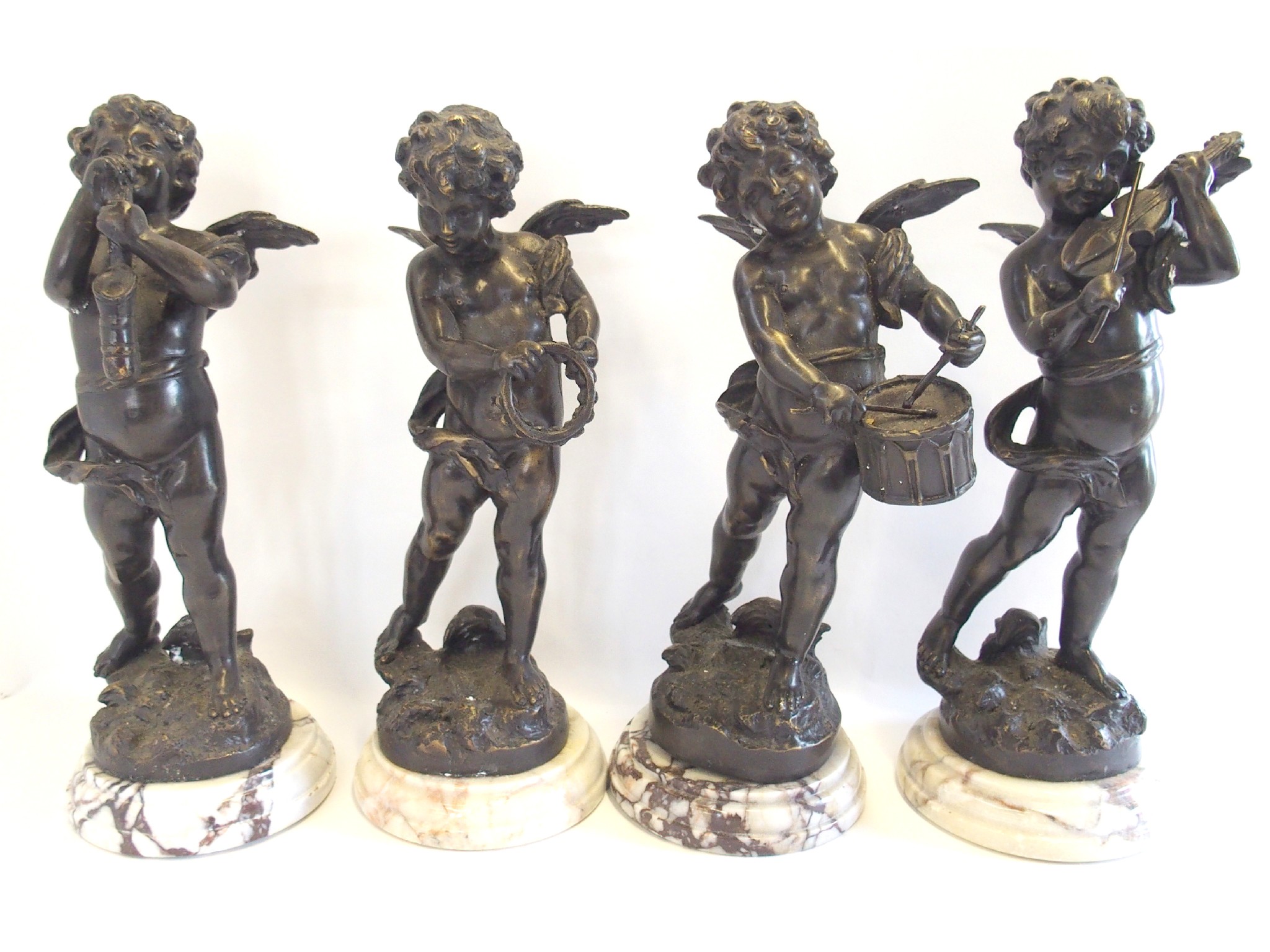 Appraisal: Bronzed metal four piece cherub band each on marble plinth