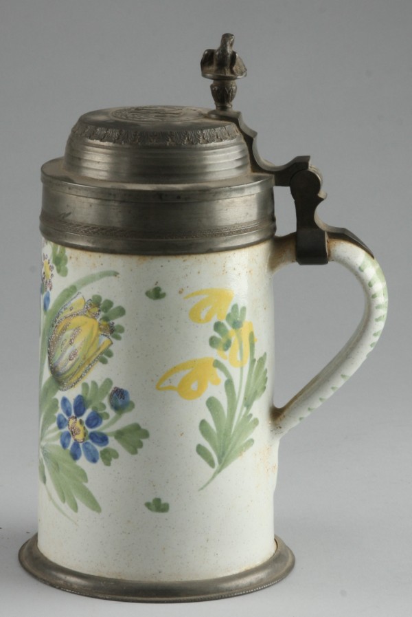 Appraisal: Tankard features floral motif t lid features Geuck Und Segen